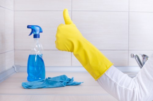 Technician using protective gloves and cleaning tools during carpet care