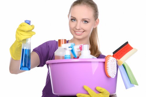 Office cleaner working around desks in a Uxbridge business premises